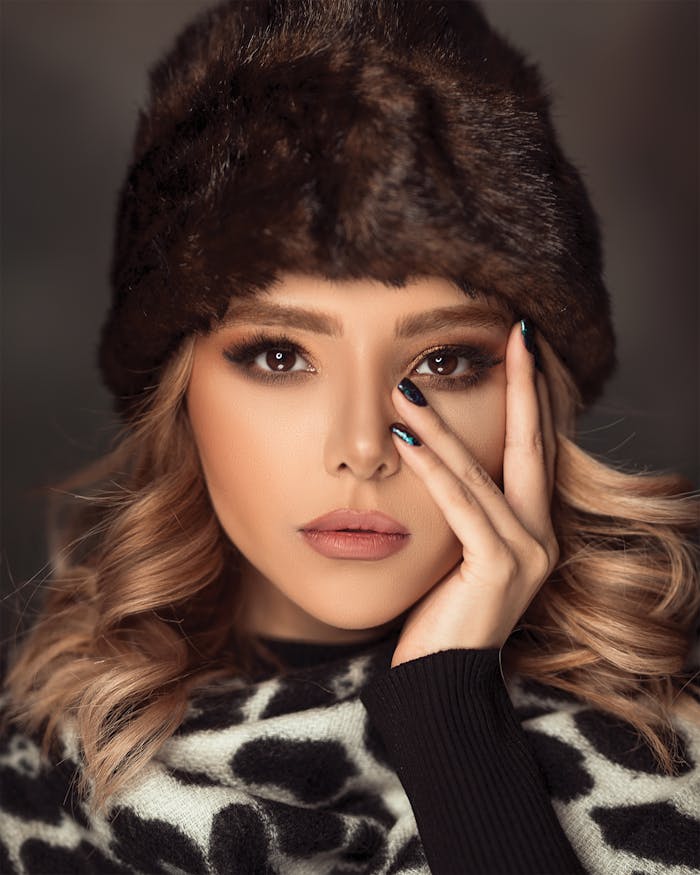 Woman Wearing Brown Fur Beanies and White and Balck Top